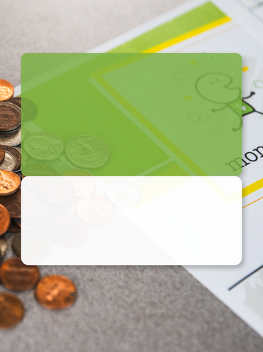 coins on a table with the money week program cover page overlayed with a green box